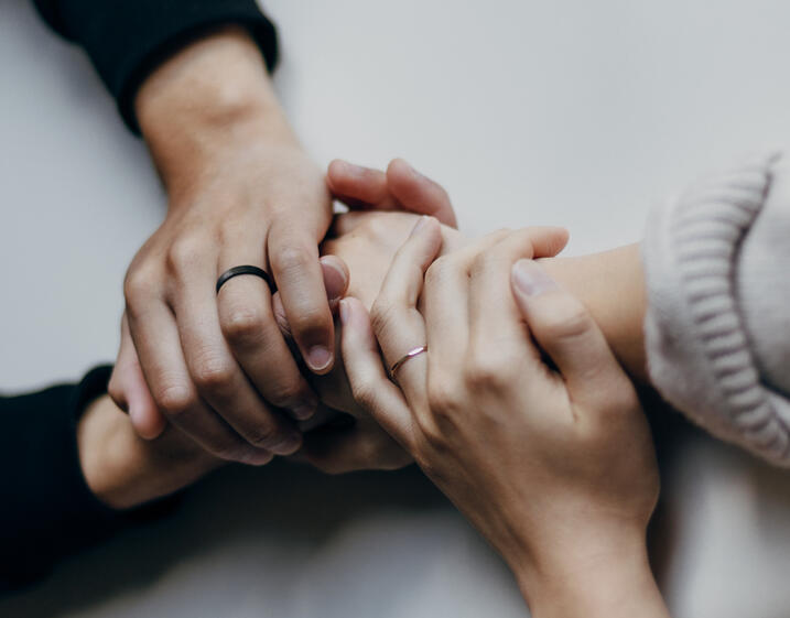 Two sets of hands intertwined in friendship